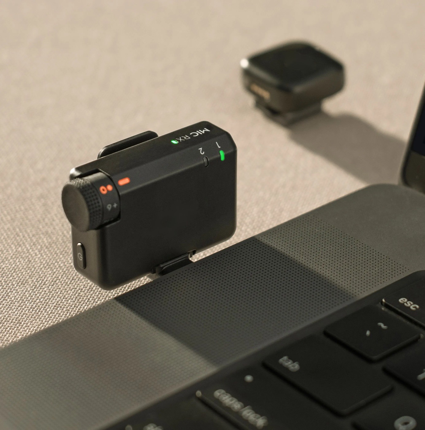 Wireless mic receiver clipped to a laptop